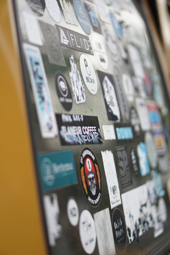 Close-up of a vibrant sticker collection on a wall in Palembang, Indonesia.